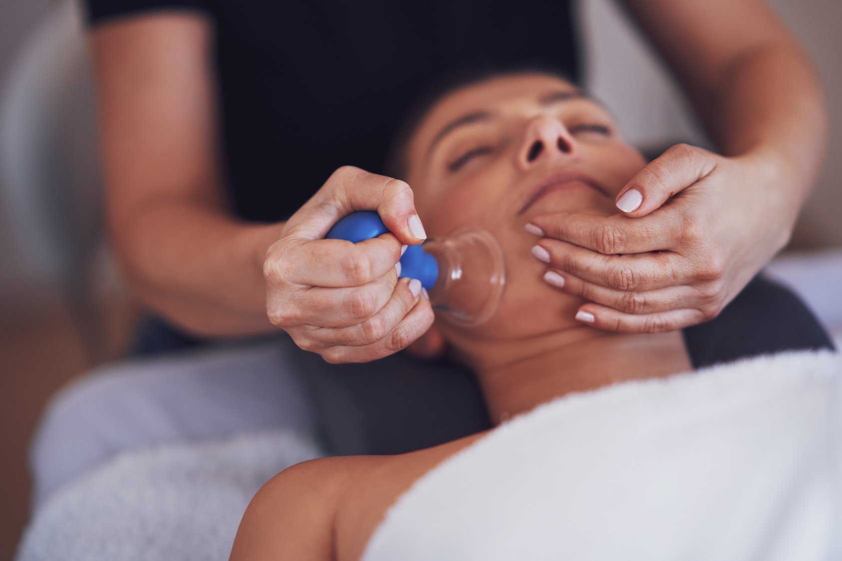 Woman Having a Face Cupping Massage in Salon